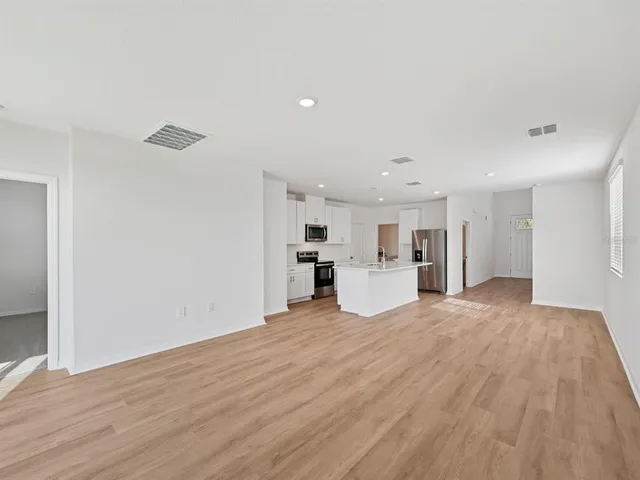a view of a kitchen with a sink and a window
