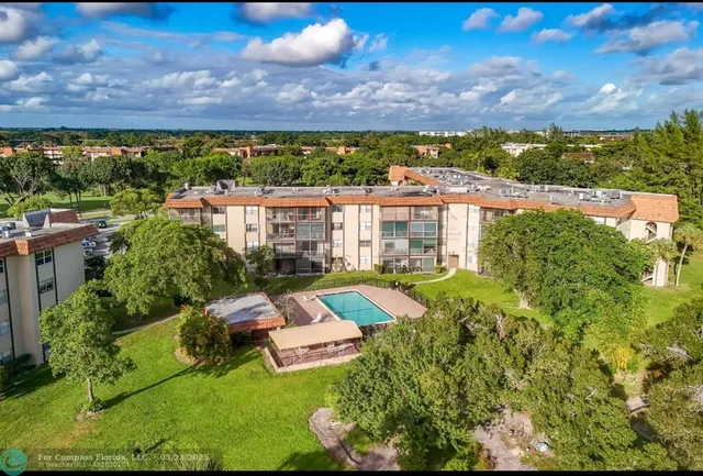 an aerial view of residential house with outdoor space and swimming pool