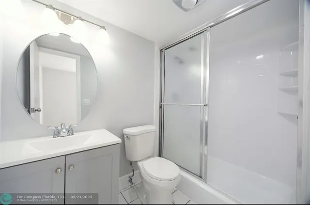 a bathroom with a toilet sink and shower