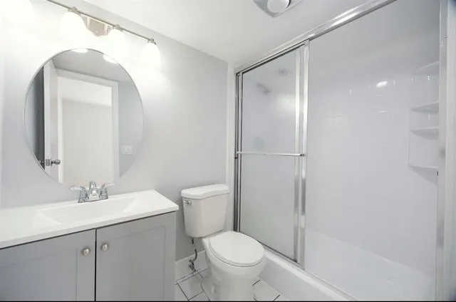 a white toilet sitting next to a bathroom sink