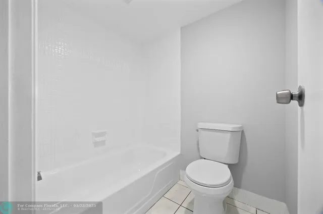 a white toilet sitting next to a bath tub