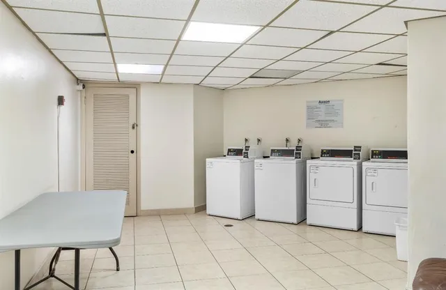 a view of kitchen with cabinets and white appliances