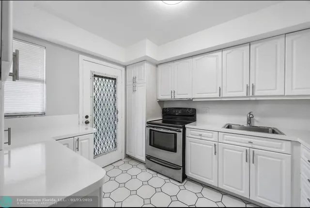 a kitchen with stainless steel appliances granite countertop a sink and a stove