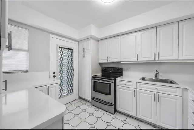 a kitchen with stainless steel appliances granite countertop a sink and a stove