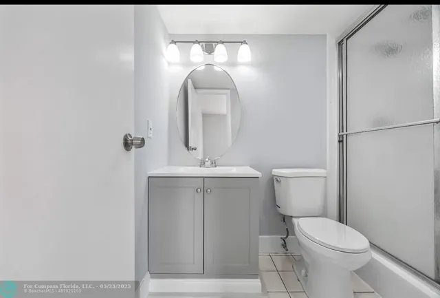 a white toilet sitting next to a bathroom sink