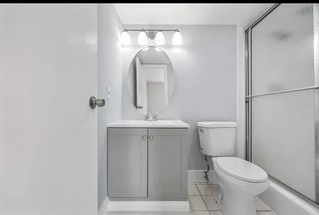 a white toilet sitting next to a bathroom sink