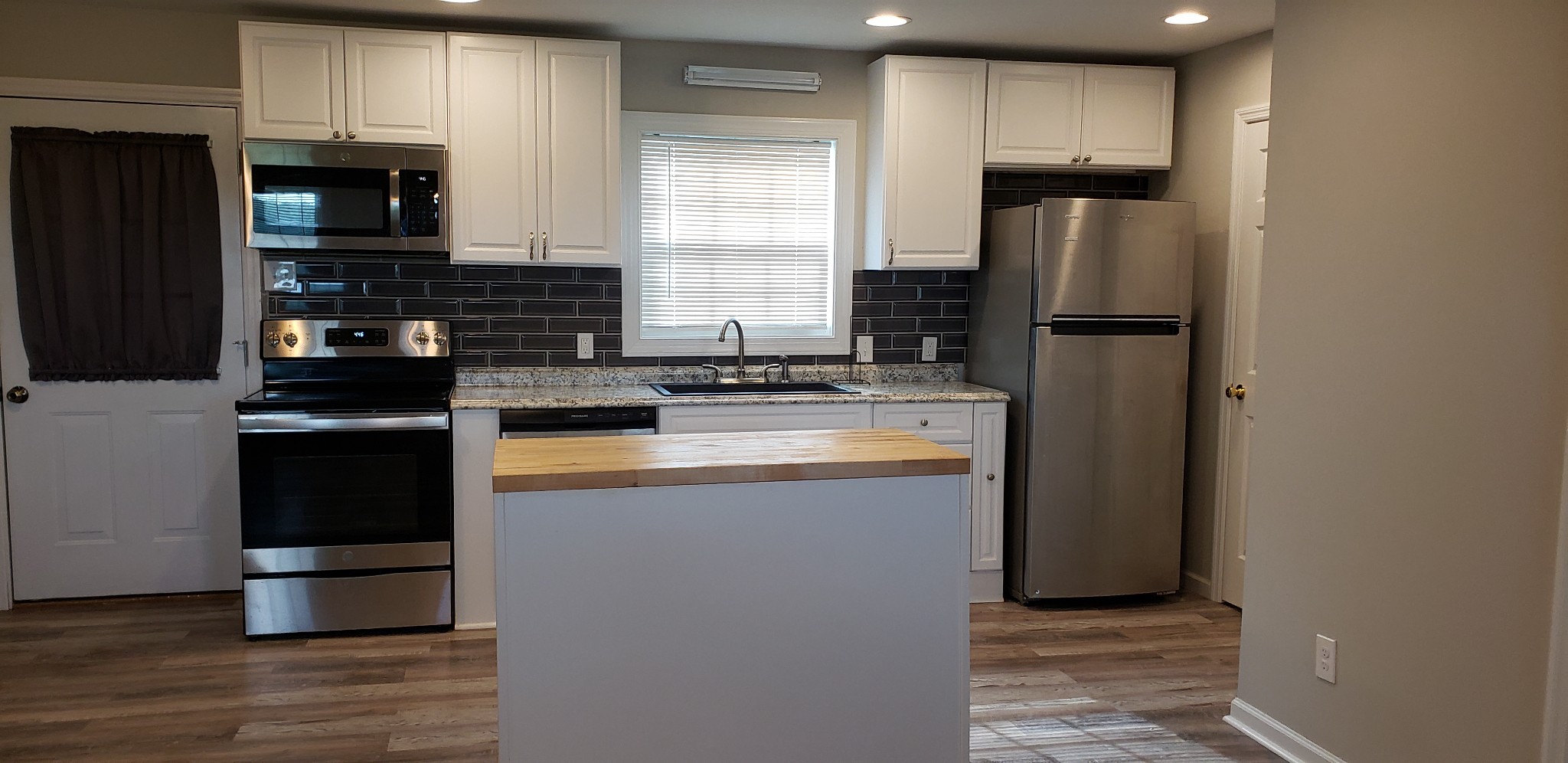 67 Orville Duke Road Morrison, TN 37357 - Photo 3 of 13 a kitchen with stainless steel appliances granite countertop a refrigerator a stove a sink and a microwave