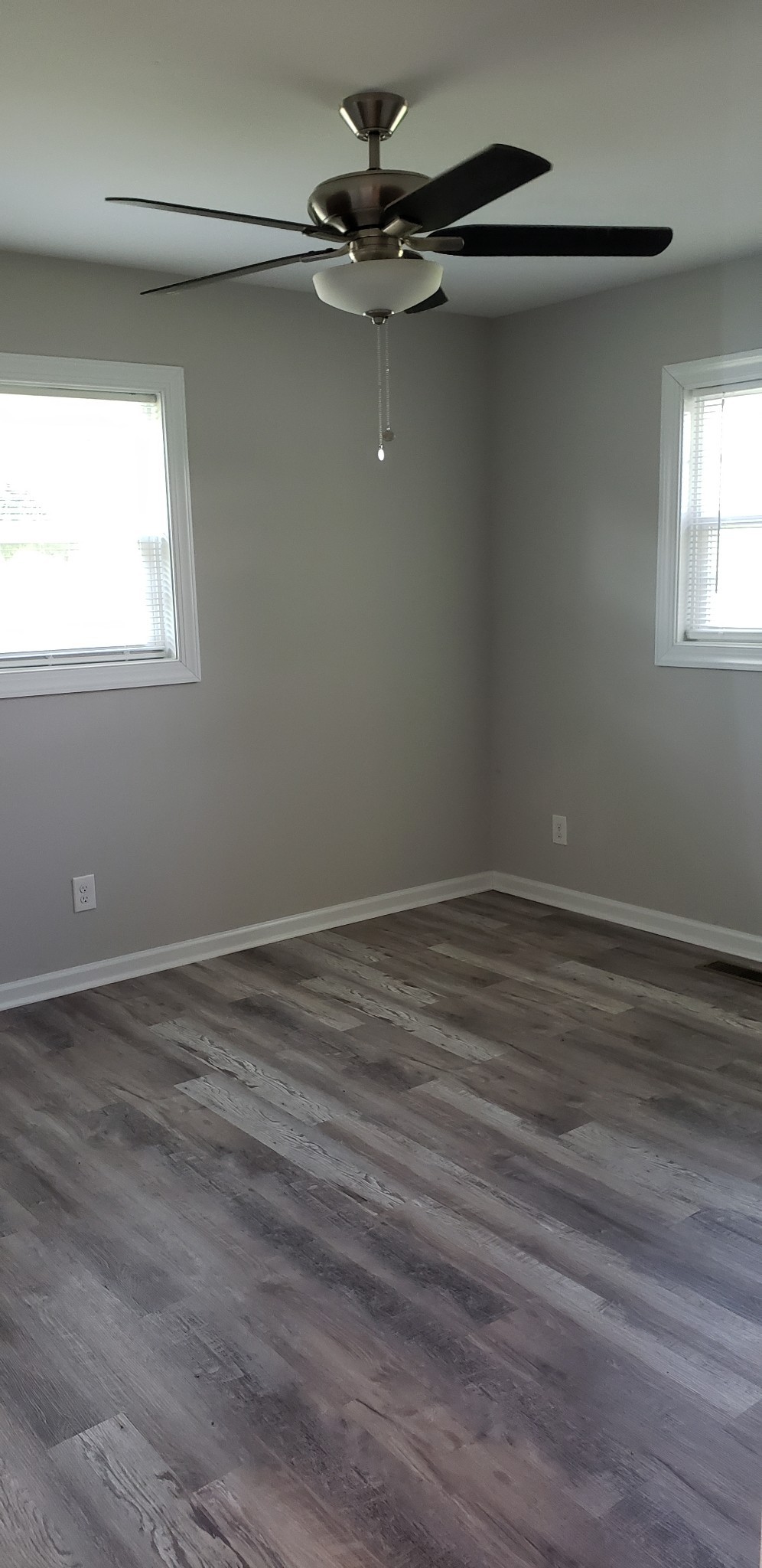 67 Orville Duke Road Morrison, TN 37357 - Photo 6 of 13 a view of a room with wooden floor a ceiling fan and windows