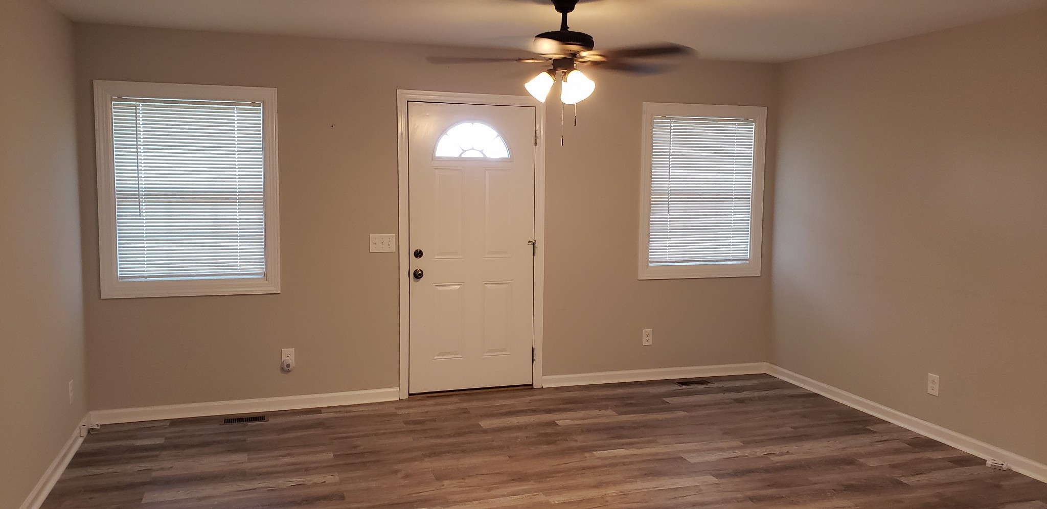 67 Orville Duke Road Morrison, TN 37357 - Photo 8 of 13 an empty room with wooden floor fan and windows