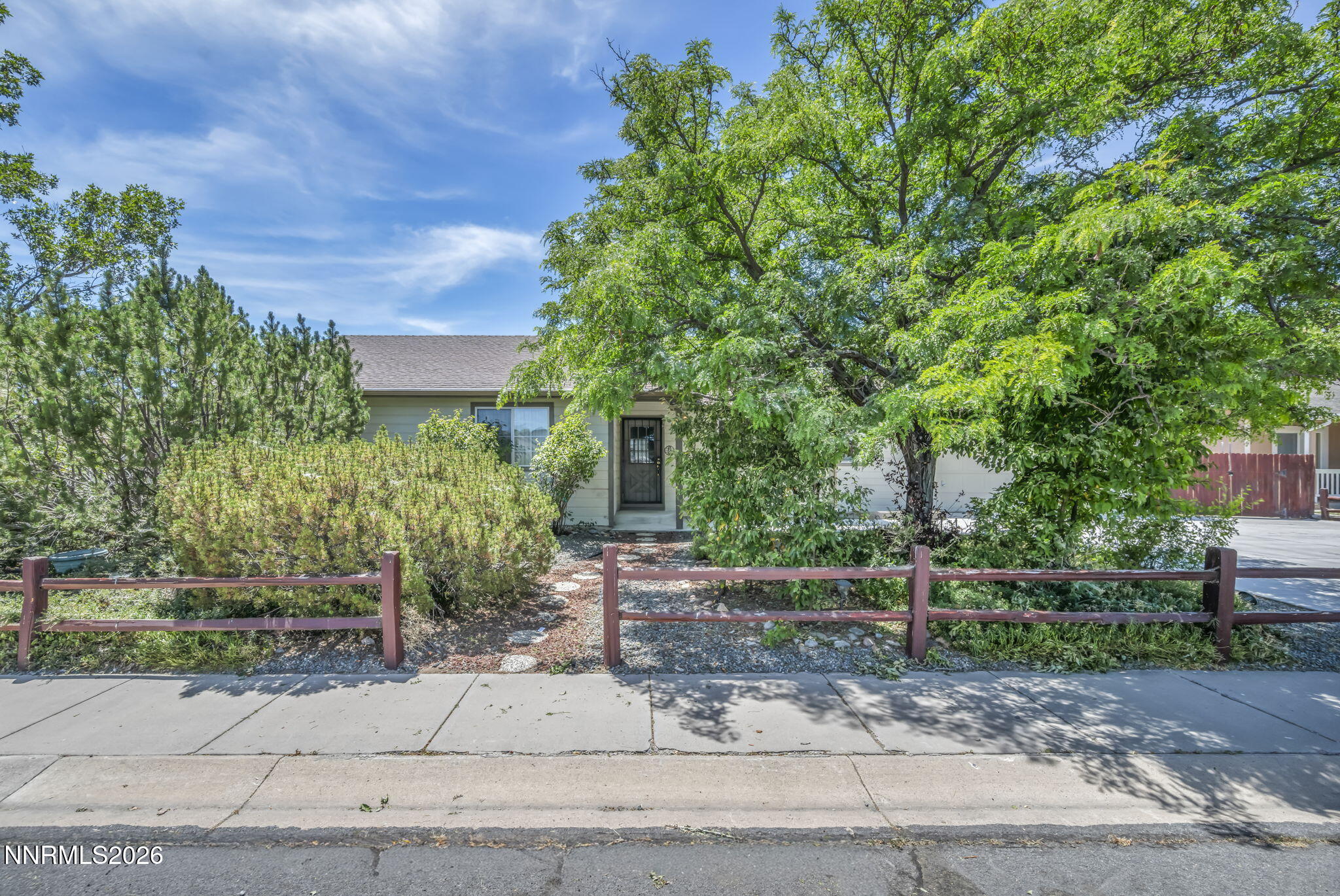 692 Lassen Way Gardnerville, NV 89460 - Photo 2 of 34 a front view of a house with a tree