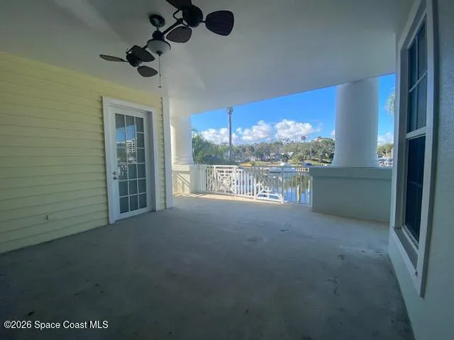 a view of a room with a ceiling fan and a window