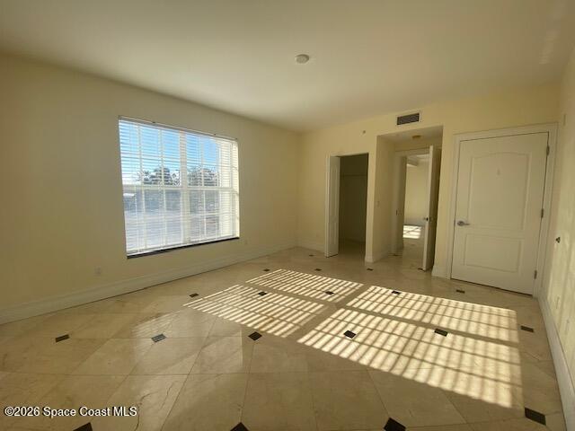 2240 Front Street, Unit 104 Melbourne, FL 32901 - Photo 32 of 37 a bedroom with a bed and a window