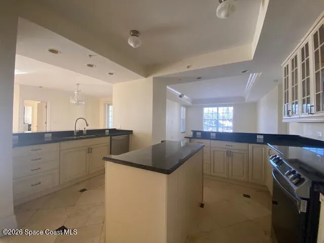 a kitchen with stainless steel appliances granite countertop a sink and cabinets