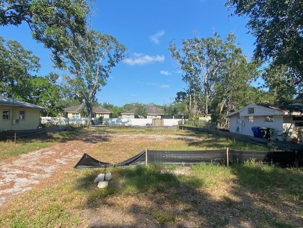 658 15th Street Northwest Largo, FL 33770 - Photo 12 of 12 a view of swimming pool with outdoor seating and trees in the background