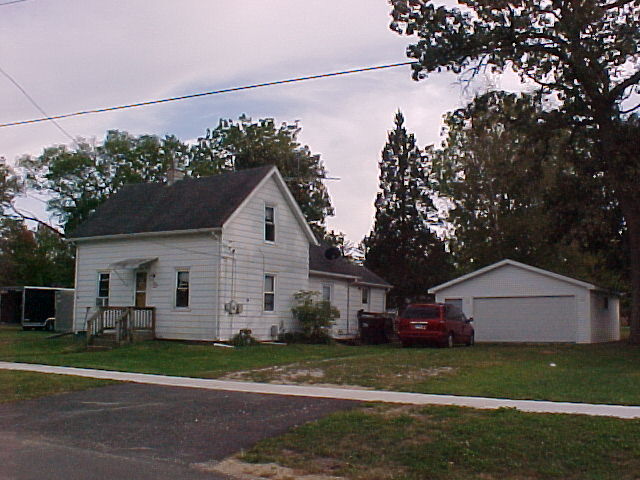 a front view of a house with a yard and a garage