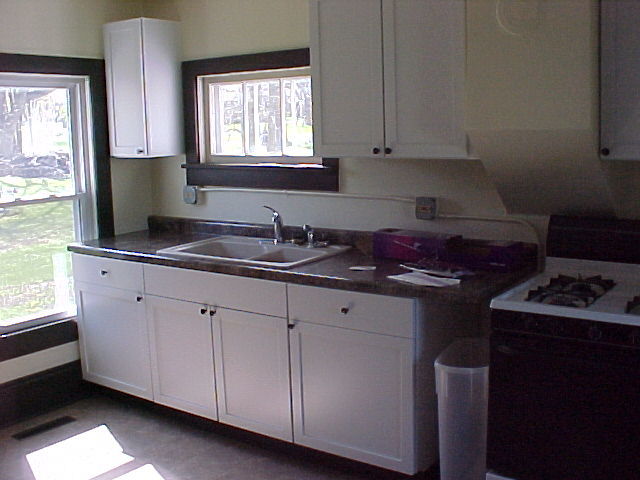 340 Ogden Street Capron, IL 61012 - Photo 4 of 11 a kitchen with granite countertop white cabinets sink and window