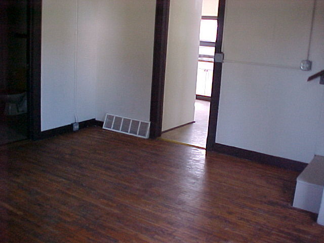 340 Ogden Street Capron, IL 61012 - Photo 8 of 11 a view of an empty room with wooden floor and a window