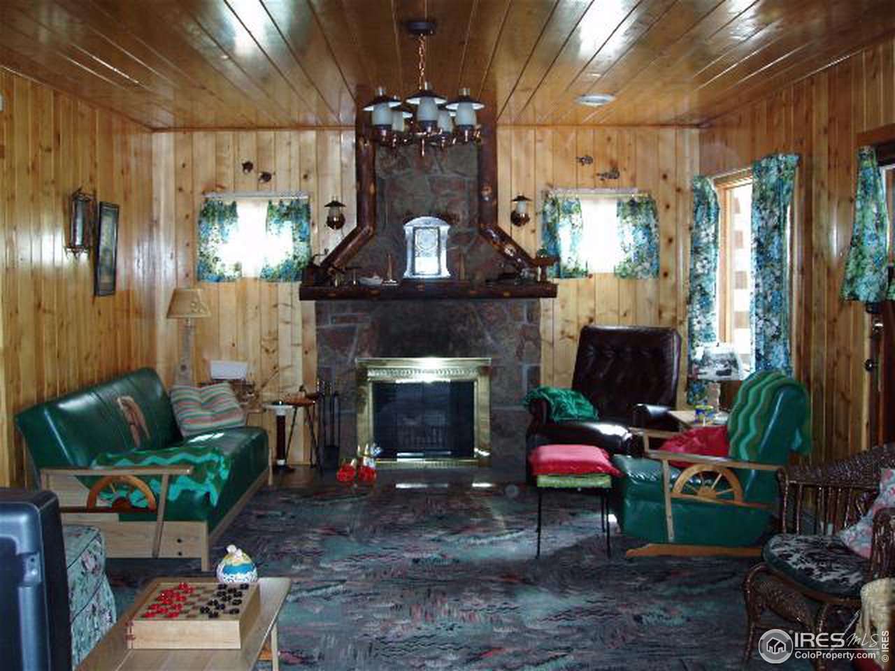 2426 Riverside Drive Lyons, CO 80540 - Photo 3 of 9 a living room with furniture and a fireplace