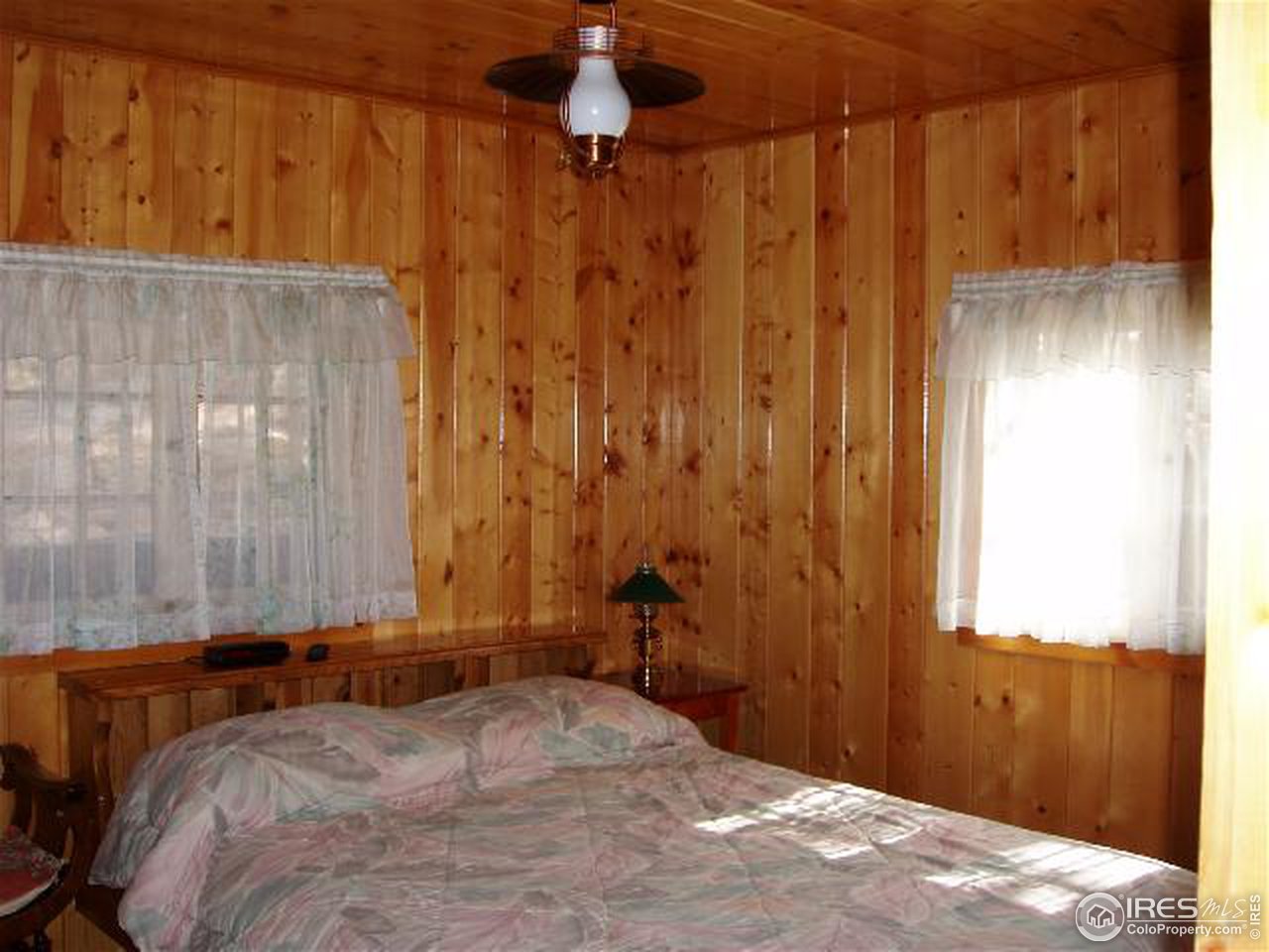 2426 Riverside Drive Lyons, CO 80540 - Photo 6 of 9 a bedroom with a bed and a window