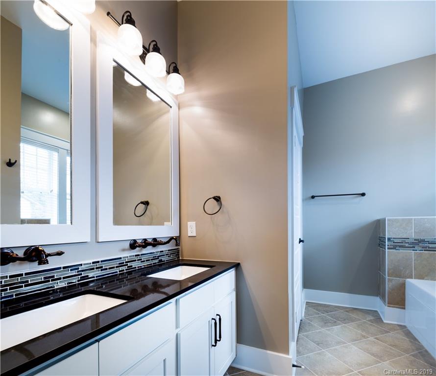 2506 McClintock Road, Unit 104 Charlotte, NC 28205 - Photo 12 of 21 a bathroom with a sink and a mirror
