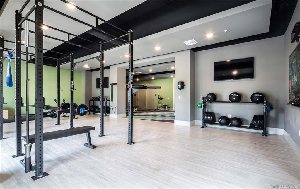2506 McClintock Road, Unit 104 Charlotte, NC 28205 - Photo 16 of 21 a gym room with lots of furniture and a flat screen tv
