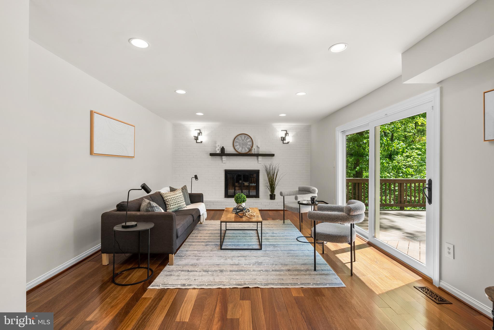 10717 Midsummer Drive Reston, VA 20191 - Photo 2 of 35 a living room with furniture and a fireplace