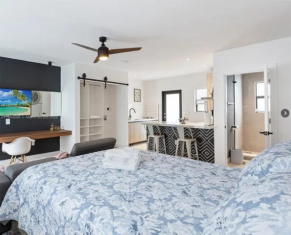 a bedroom with a bed and a bathroom