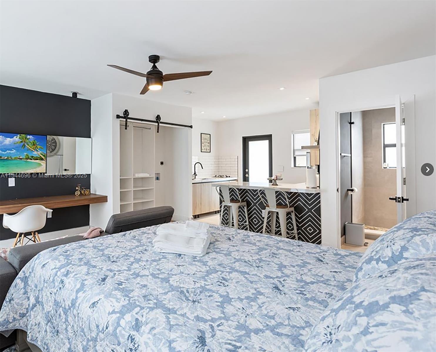 a bedroom with a bed and a bathroom