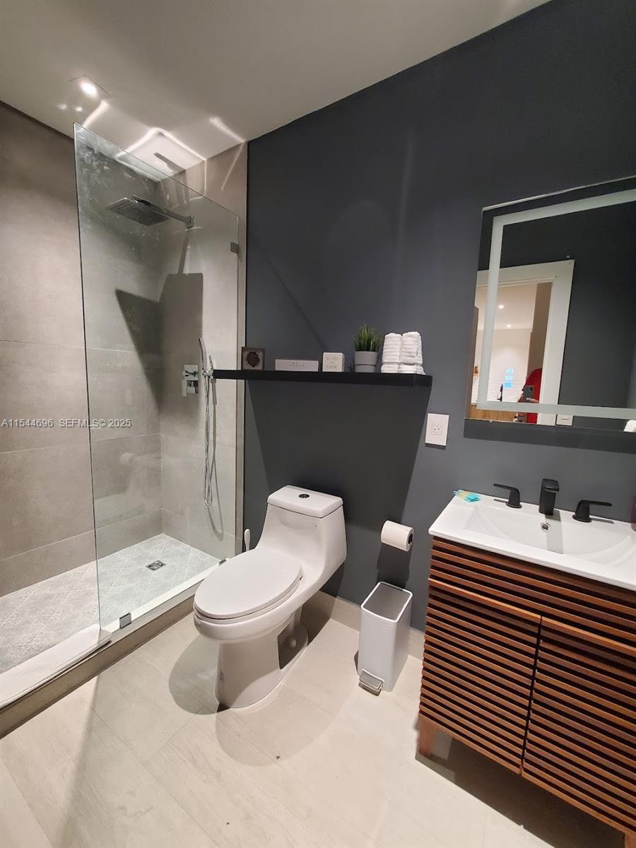 740 Southwest 9th Street, Unit 2 Miami, FL 33130 - Photo 11 of 42 a bathroom with a sink toilet and shower