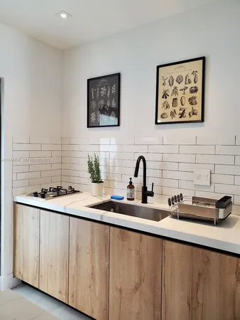 a kitchen with stainless steel appliances a sink a stove and a refrigerator