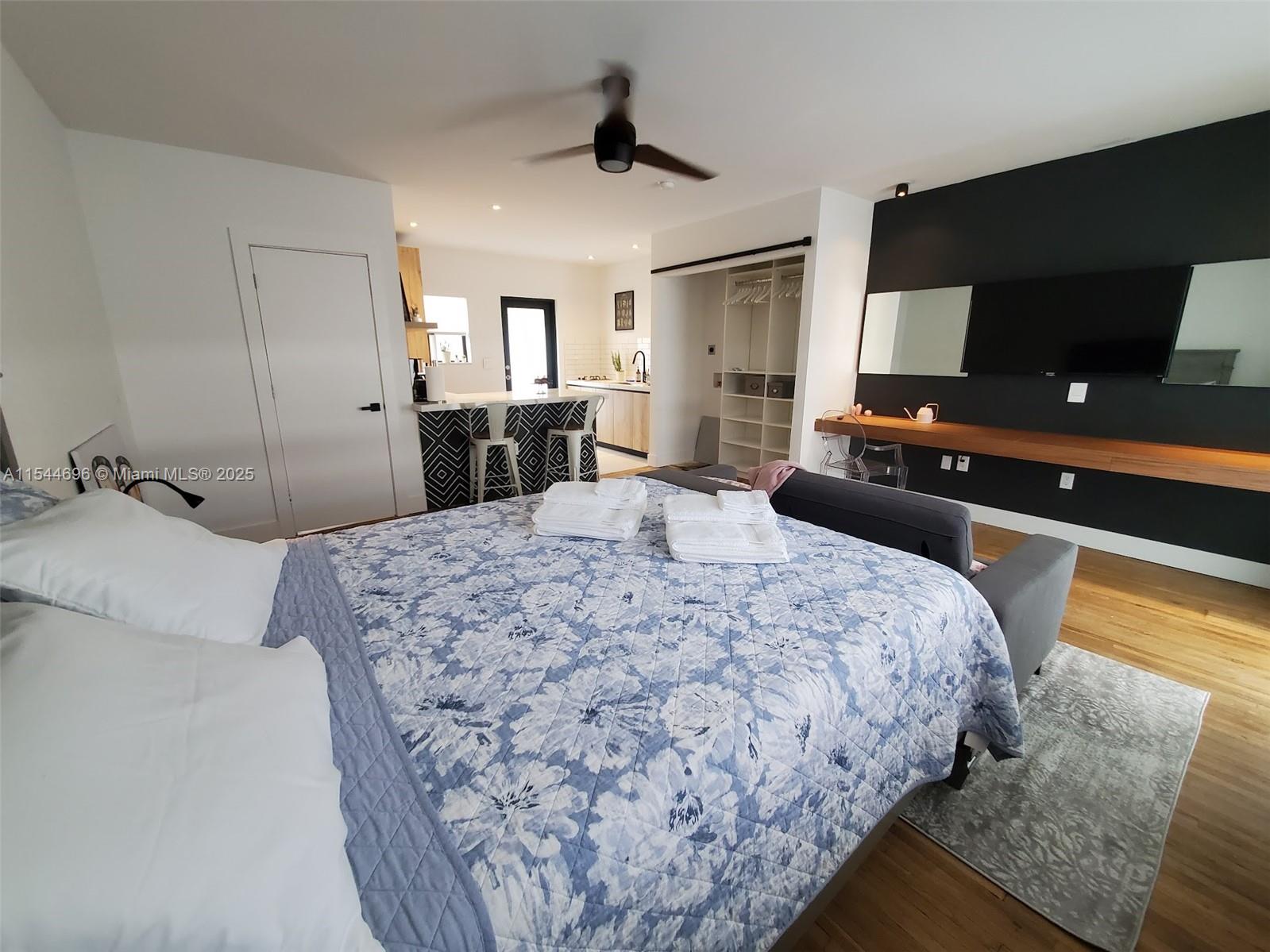 740 Southwest 9th Street, Unit 2 Miami, FL 33130 - Photo 14 of 42 a bedroom with a bed and a flat tv screen on wall