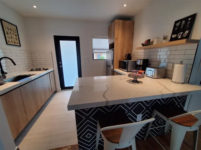 a kitchen with a table chairs and a stove
