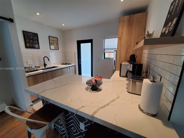 a view of a dining room with furniture and a potted plant