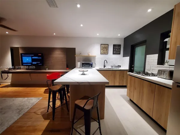 a large kitchen with a table and chairs