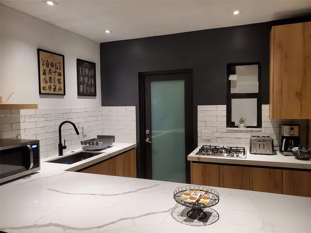 a kitchen with a sink and a stove top oven