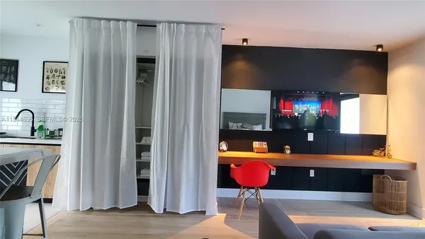 a room with furniture a flat screen tv and a fireplace