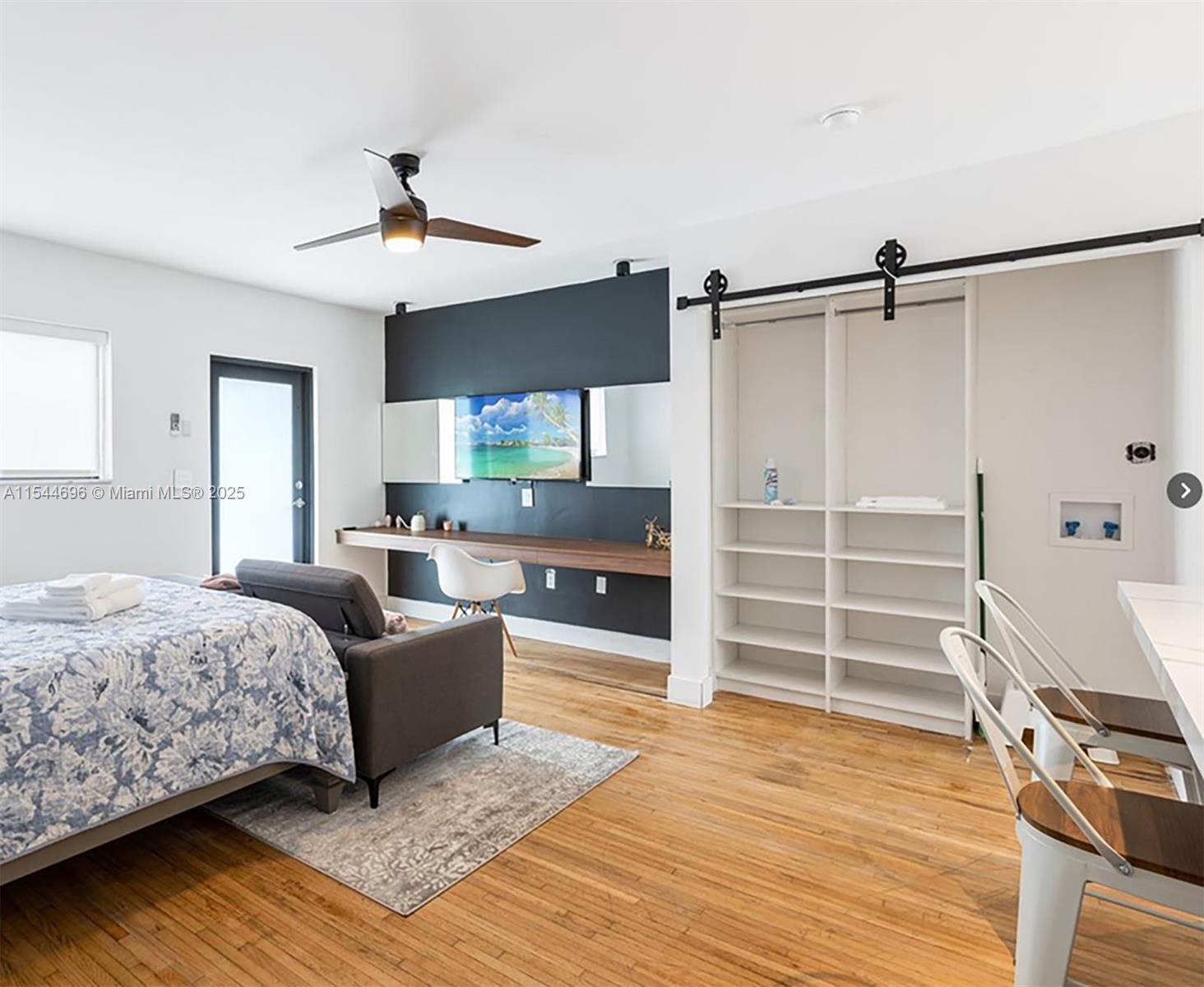 740 Southwest 9th Street, Unit 2 Miami, FL 33130 - Photo 3 of 42 a bedroom with a bed and wooden floor