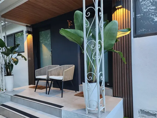 a view of living room with furniture and potted plant