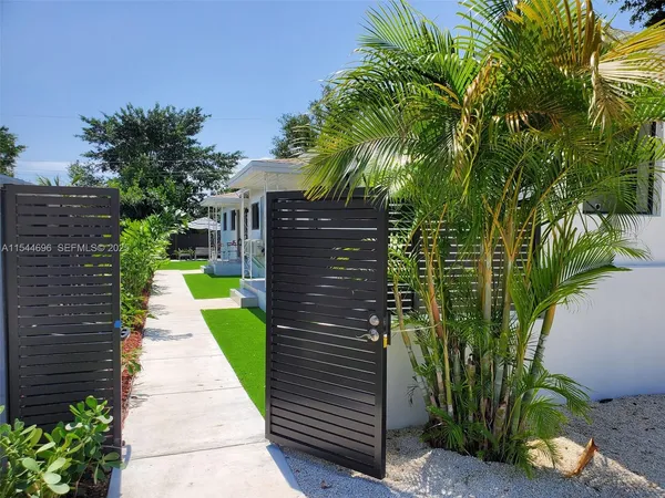 a view of a pathway both side of the house