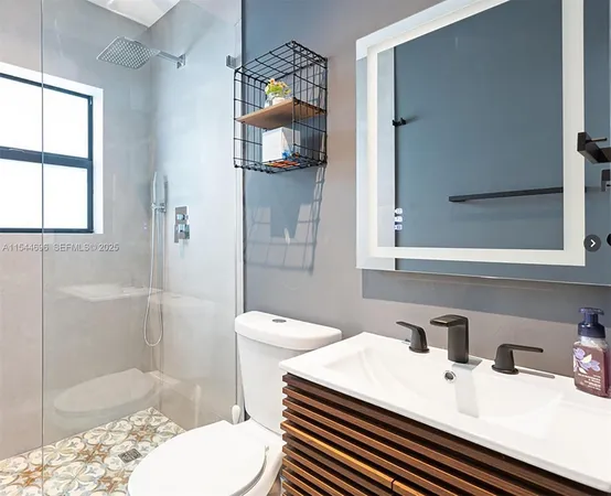 a bathroom with a sink toilet and shower