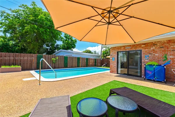 a house view with a backyard space and sitting area
