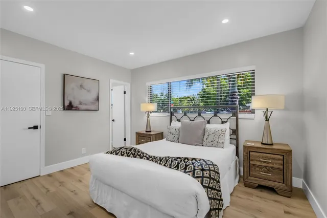 a bedroom with a large bed and a window