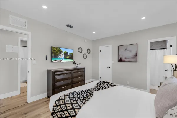 a bedroom with a bed and a dresser