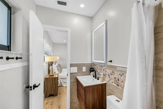 a bathroom with a sink vanity and mirror