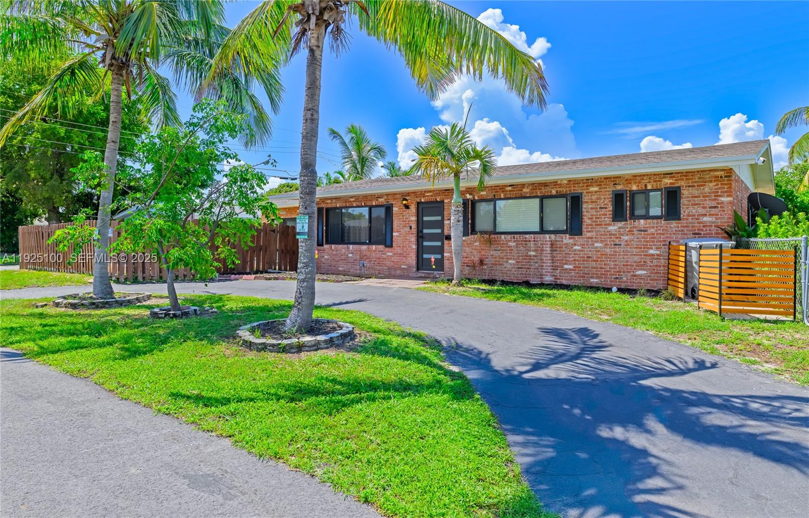 1204 Northeast 7th Street Pompano Beach, FL 33060 - Photo 2 of 43 a front view of a house with a garden and plants