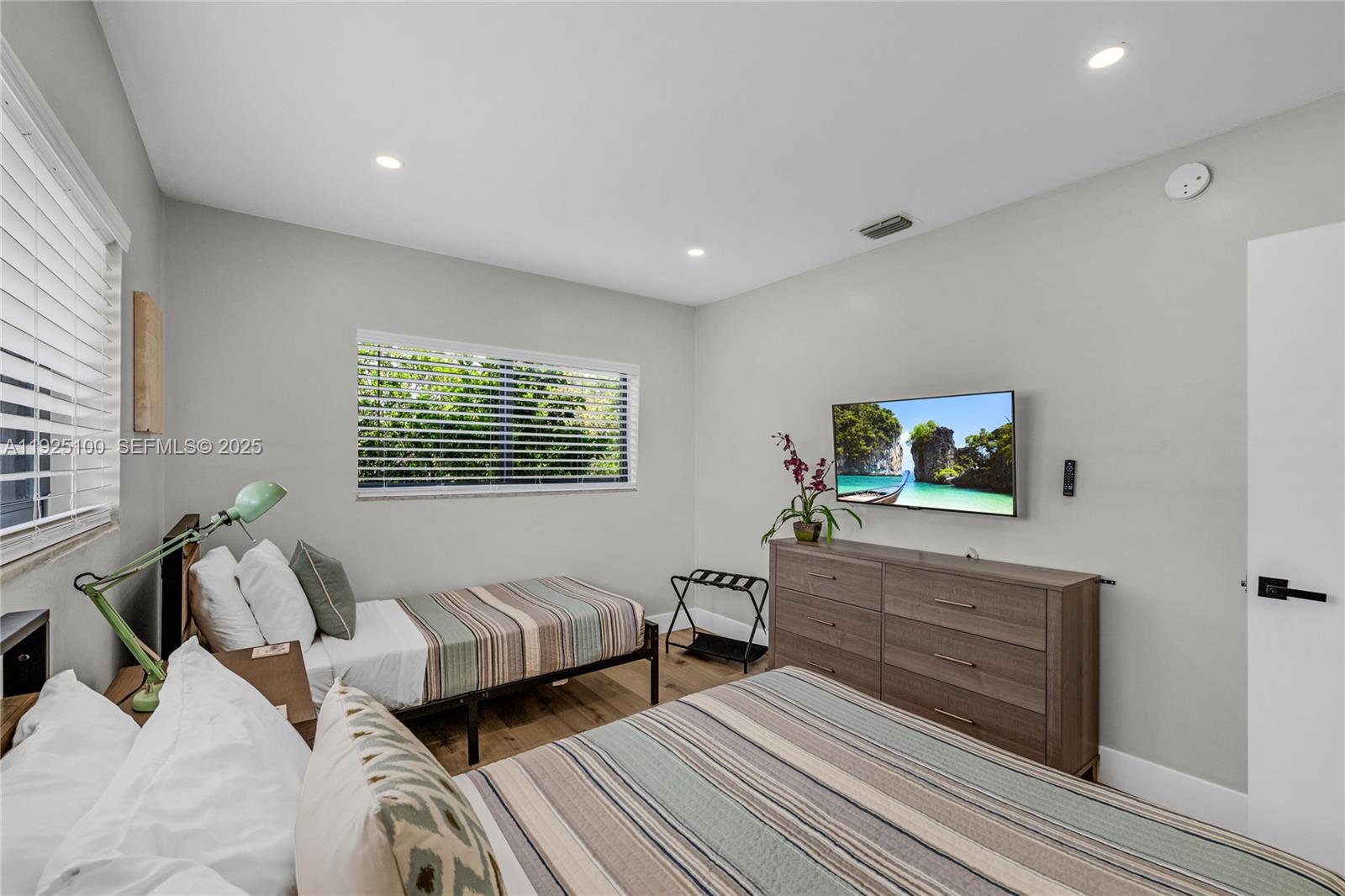 1204 Northeast 7th Street Pompano Beach, FL 33060 - Photo 23 of 43 a bedroom with two beds and a dresser