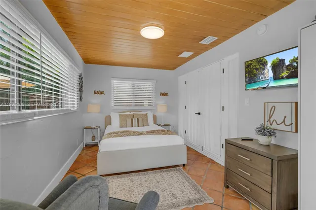 a room with a bed and a dresser