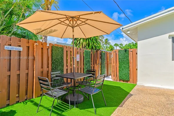 a front view of a house with table and chairs