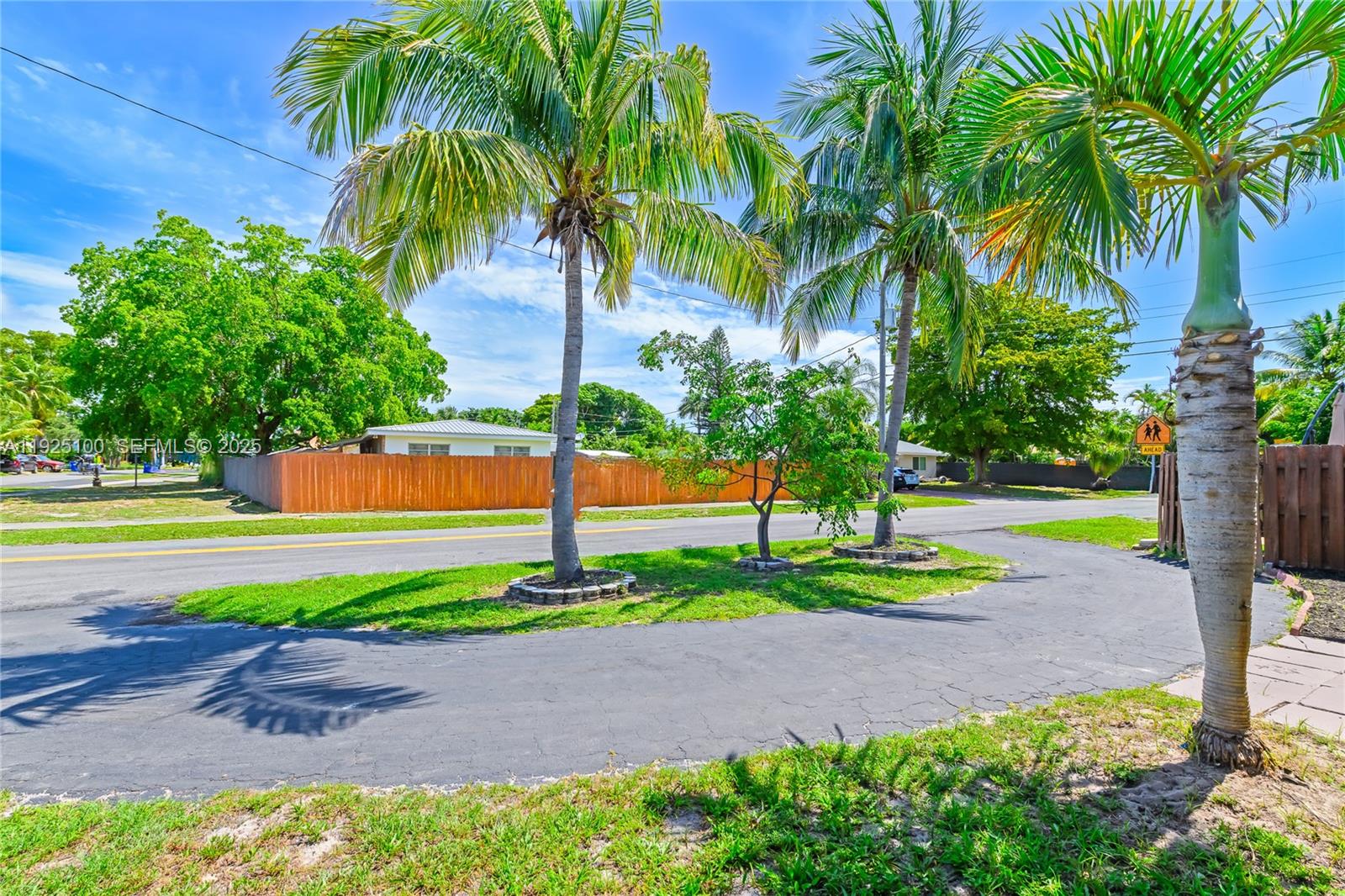 1204 Northeast 7th Street Pompano Beach, FL 33060 - Photo 36 of 43 a front view of a house with a yard and palm trees
