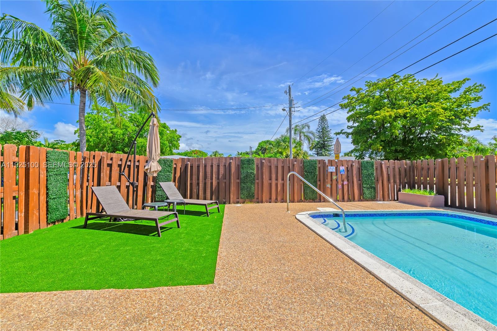 1204 Northeast 7th Street Pompano Beach, FL 33060 - Photo 38 of 43 a view of a chair and table on the wooden deck